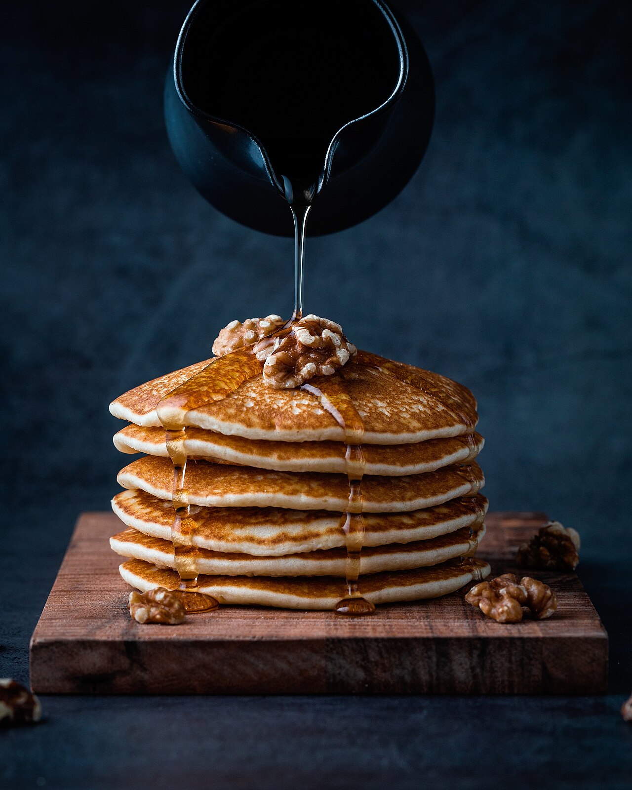 Foodiesfeed.com_pouring-honey-on-pancakes-with-walnuts